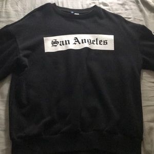 I’m selling a black designer San Angeles sweater